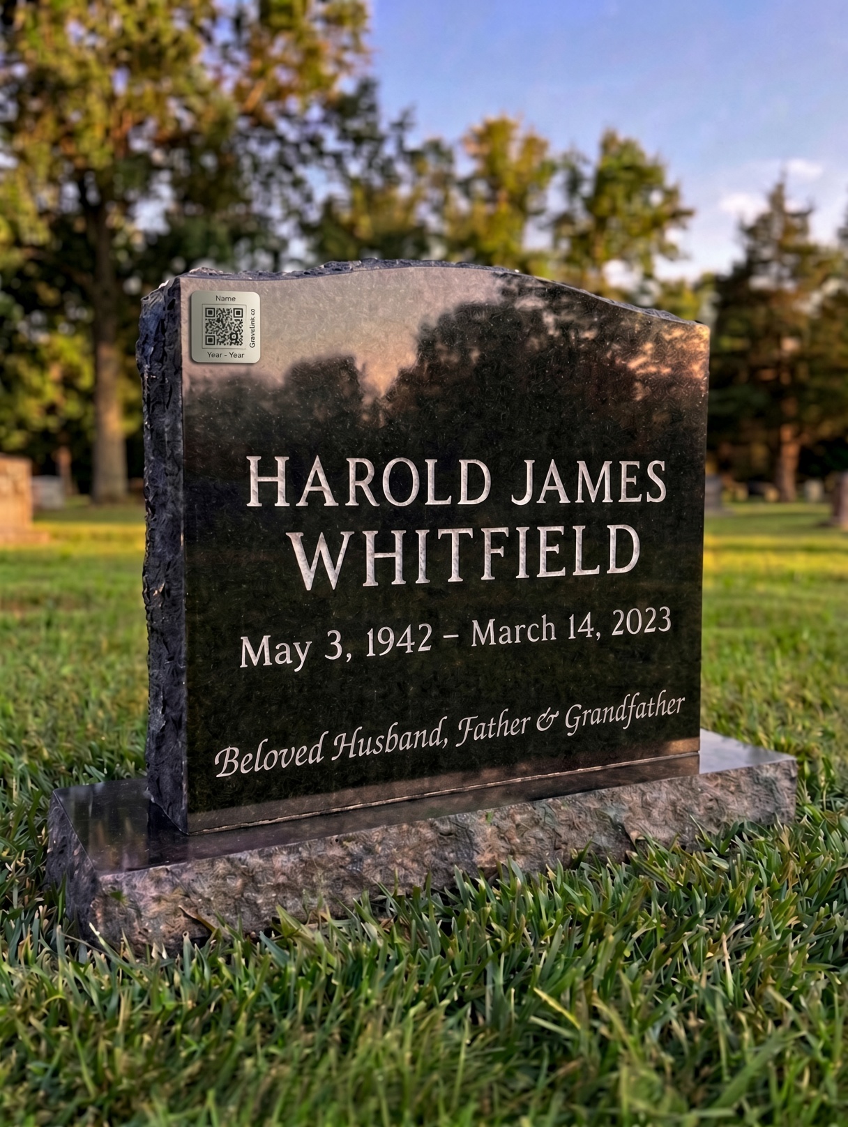 A granite headstone for Harold James Whitfield with a small engraved GraveLink QR marker attached to the upper left